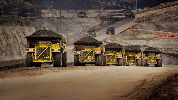 Caterpillar trucks working in the oil sands in Alberta. In response to proposed European Union rules, a new Alberta government-sponsored study says oil sands crude is not significantly higher in greenhouse gas footprint than other crudes used in Europe. (Jim Dugan/Caterpillar/Jim Dugan/Caterpillar)