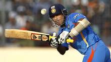 In this Friday, March 16, 2012 file photo, Indian cricketer Sachin Tendulkar bats on his way to scoring a century during the Asia Cup cricket match against Bangladesh, in Dhaka, Bangladesh. India's batting great Tendulkar has announced Sunday, Dec. 23, 2012 his retirement from one-day cricket. (Aijaz Rahi /AP)
