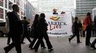 Barrick shareholders walk by protesters outside the Metro Toronto Convention Centre.