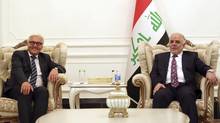 Iraq's Prime Minister-designate Haider al-Abadi (R) meets with German's Foreign Minister Frank-Walter Steinmeier in Baghdad Aug. 16. (POOL/REUTERS)